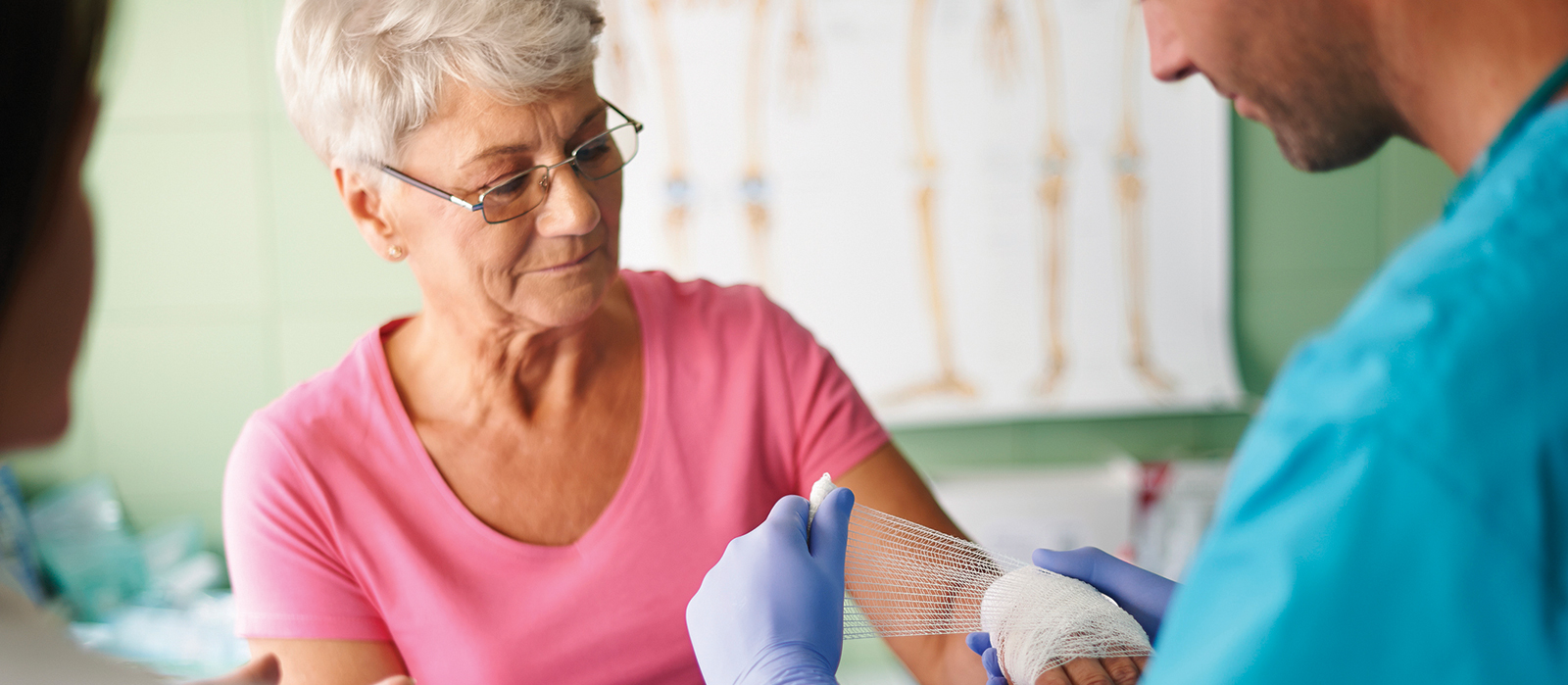 older woman receiving wound treatment