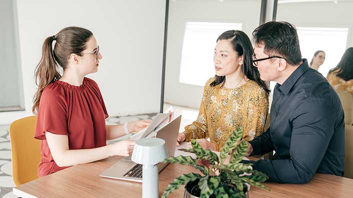 Asian couple consulting with genetic counselor