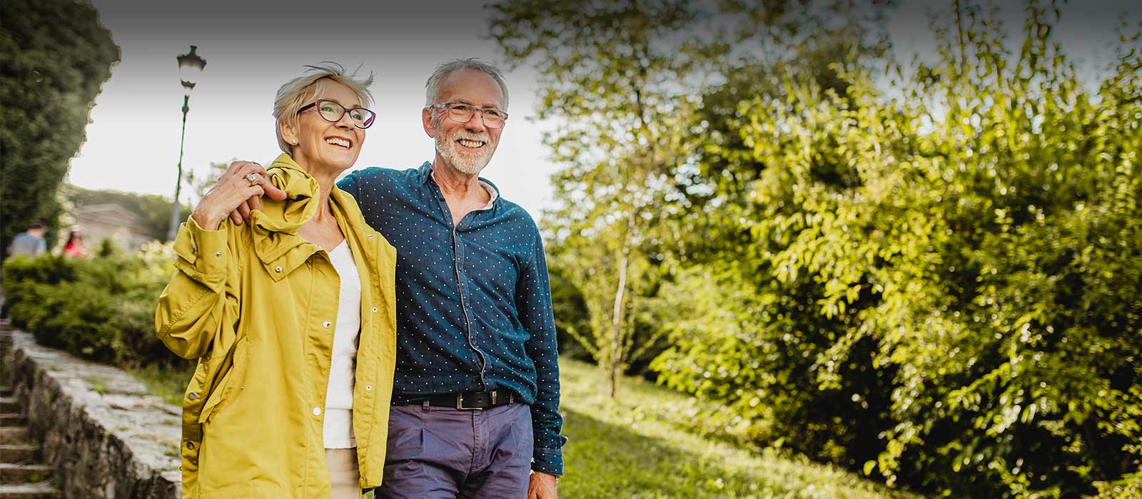 Happy mature couple walking outdoors down stairs