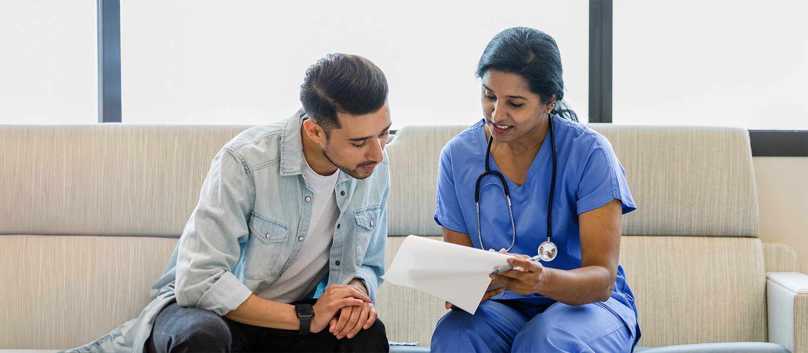 A female doctor with a male patient