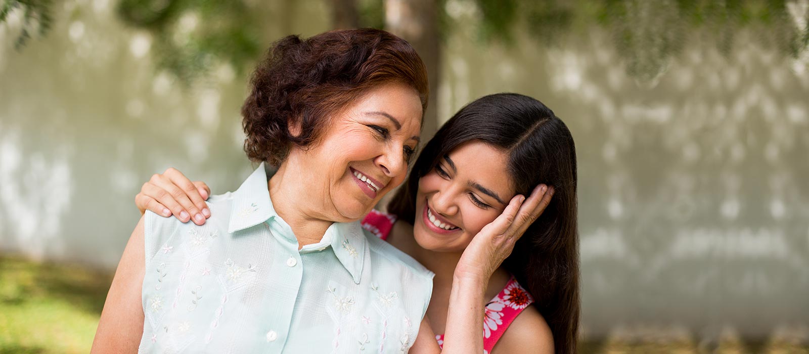 Grandmother and grand daughter embracing 