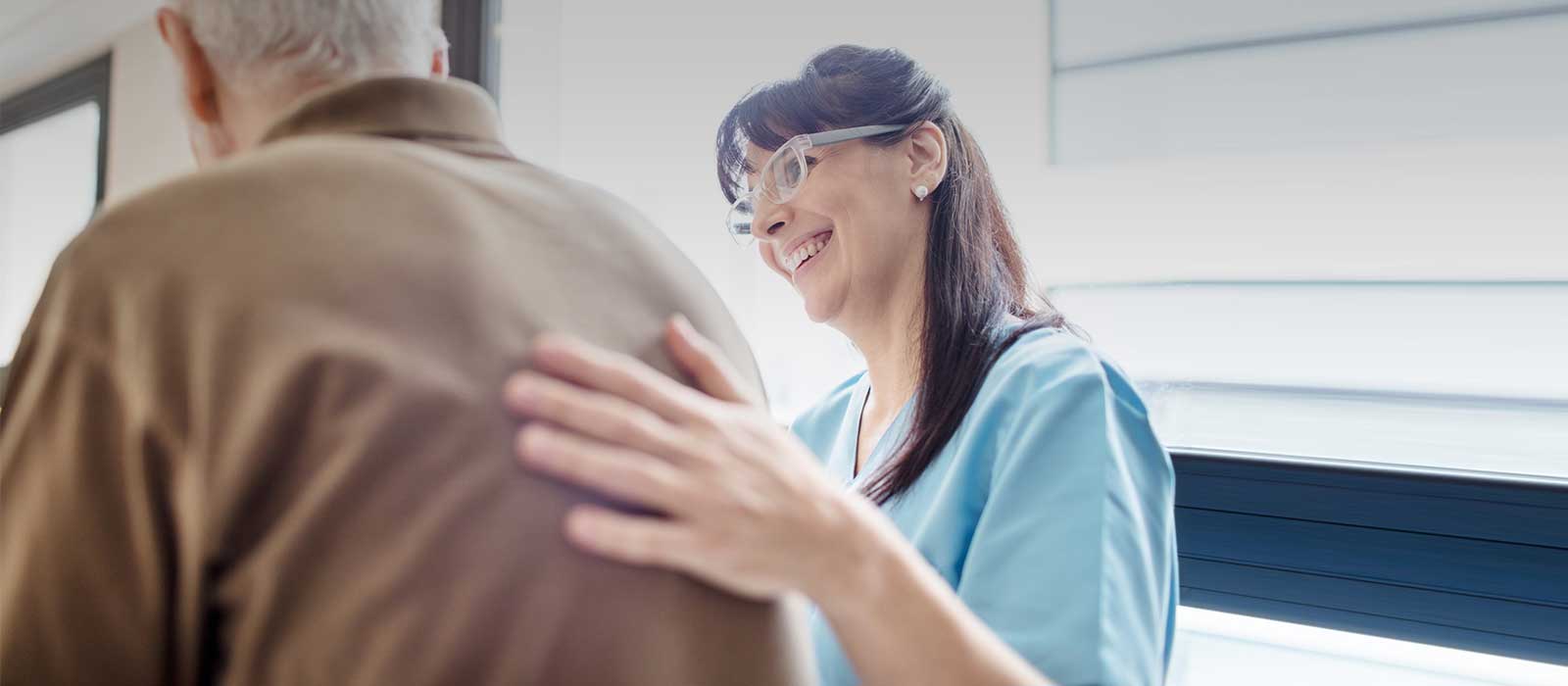 Nurse greeting mature patient