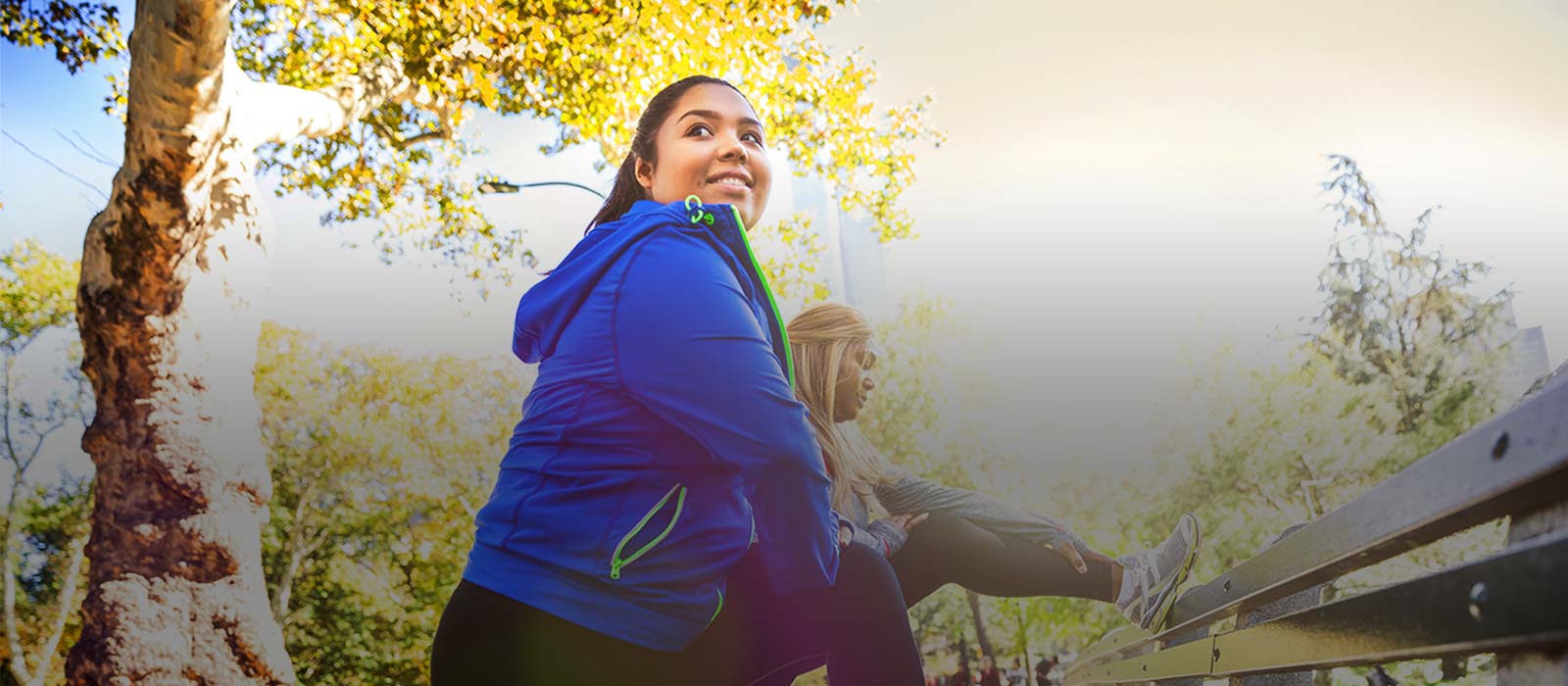 Two female fitness partners outdoors