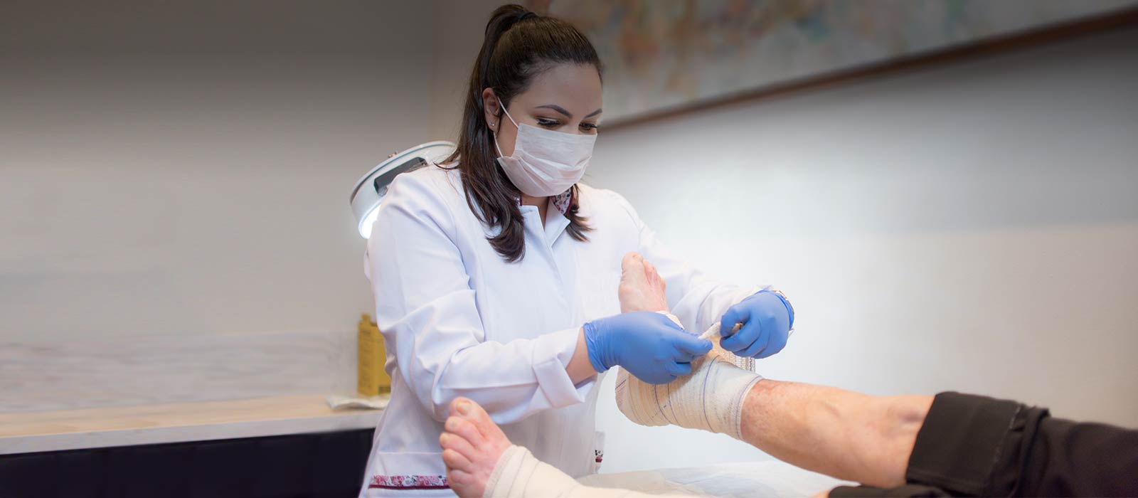 Medical specialist wrapping foot 