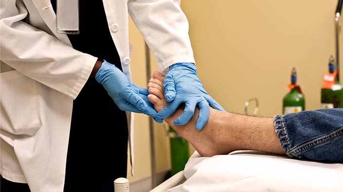 Close up of doctor evaluating foot wound