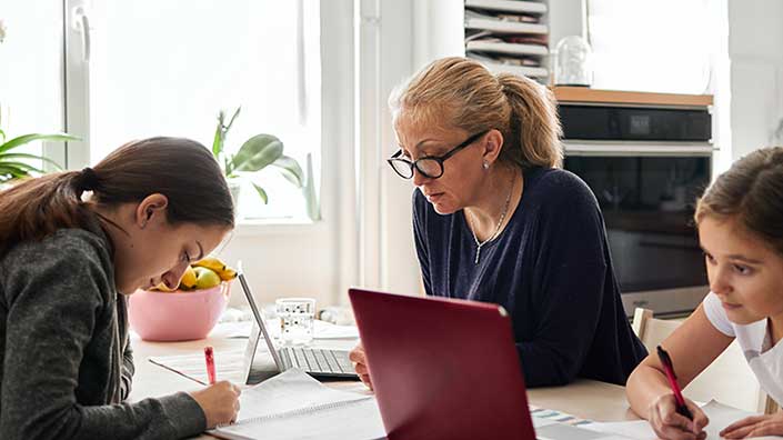 Mom selecting insurance coverage on her laptop