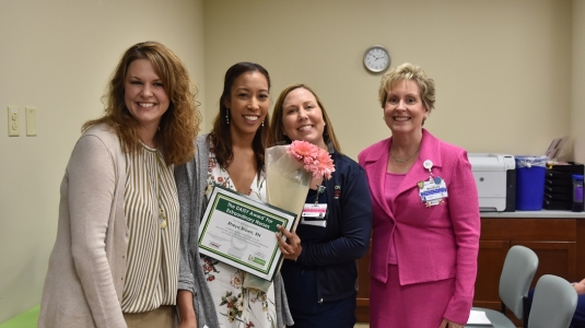 four nurses smiling