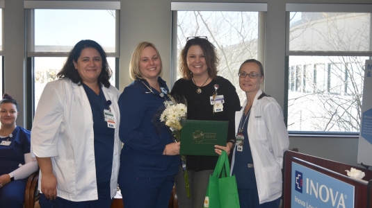 four nurses smiling